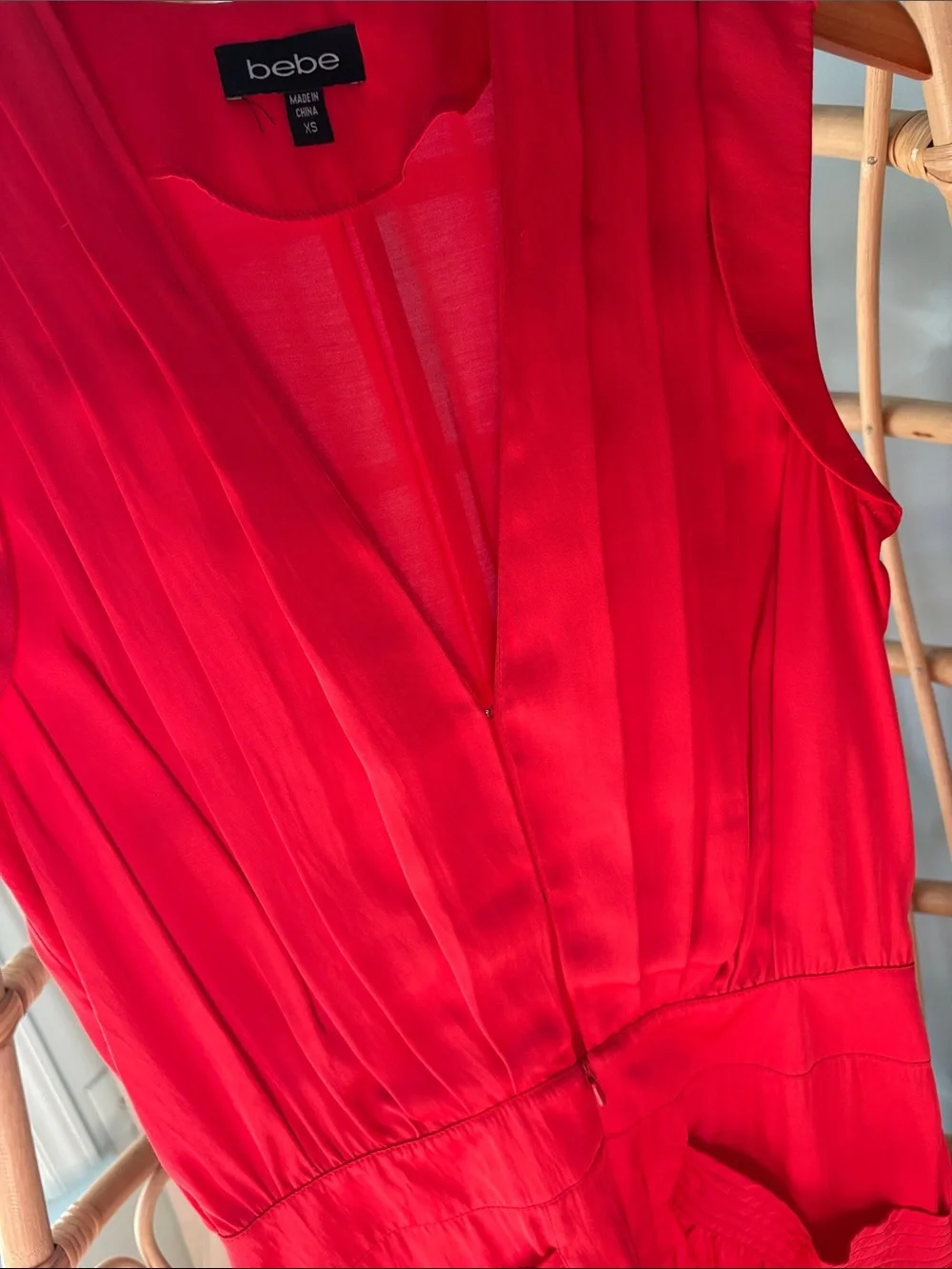 Beautiful Bebe satin vibrant red/orange romper with gold accents.
